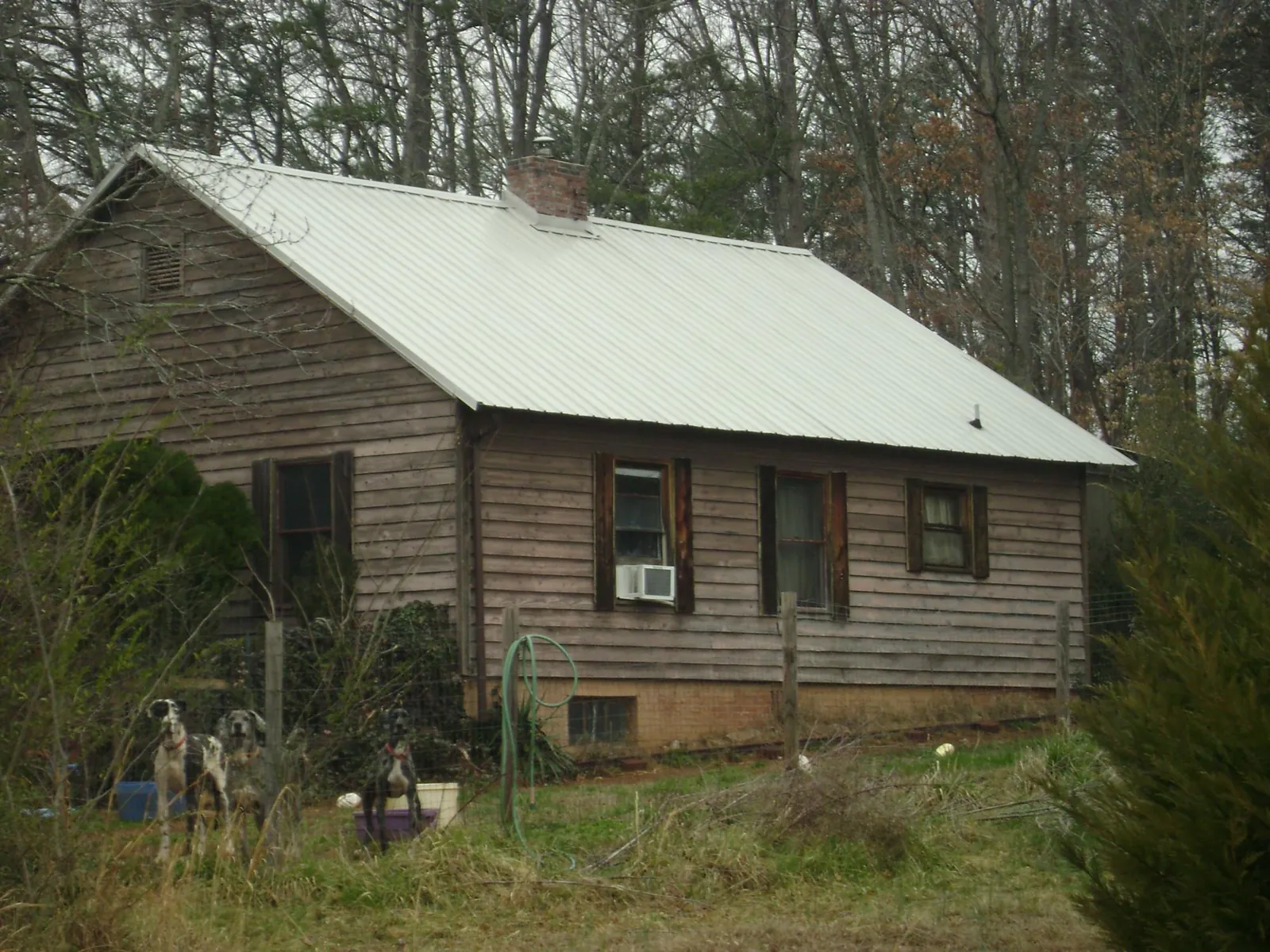 White metal roof on an old wood sided farmhouse, from a Metal Roof Installation job in Pelahatchie